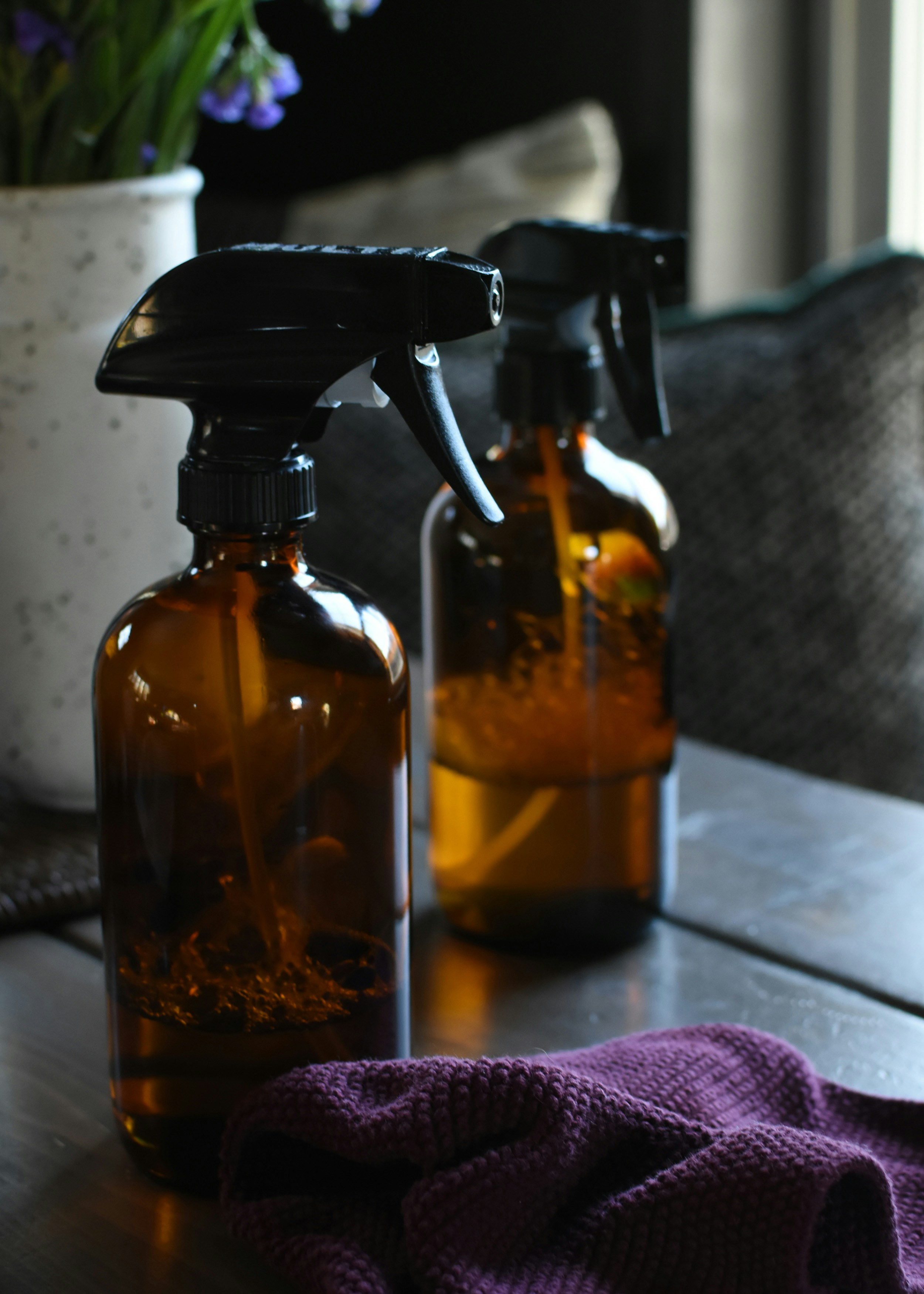 Refill bottles, concentrate pods and package-free soap bars arranged on a surface, natural light
