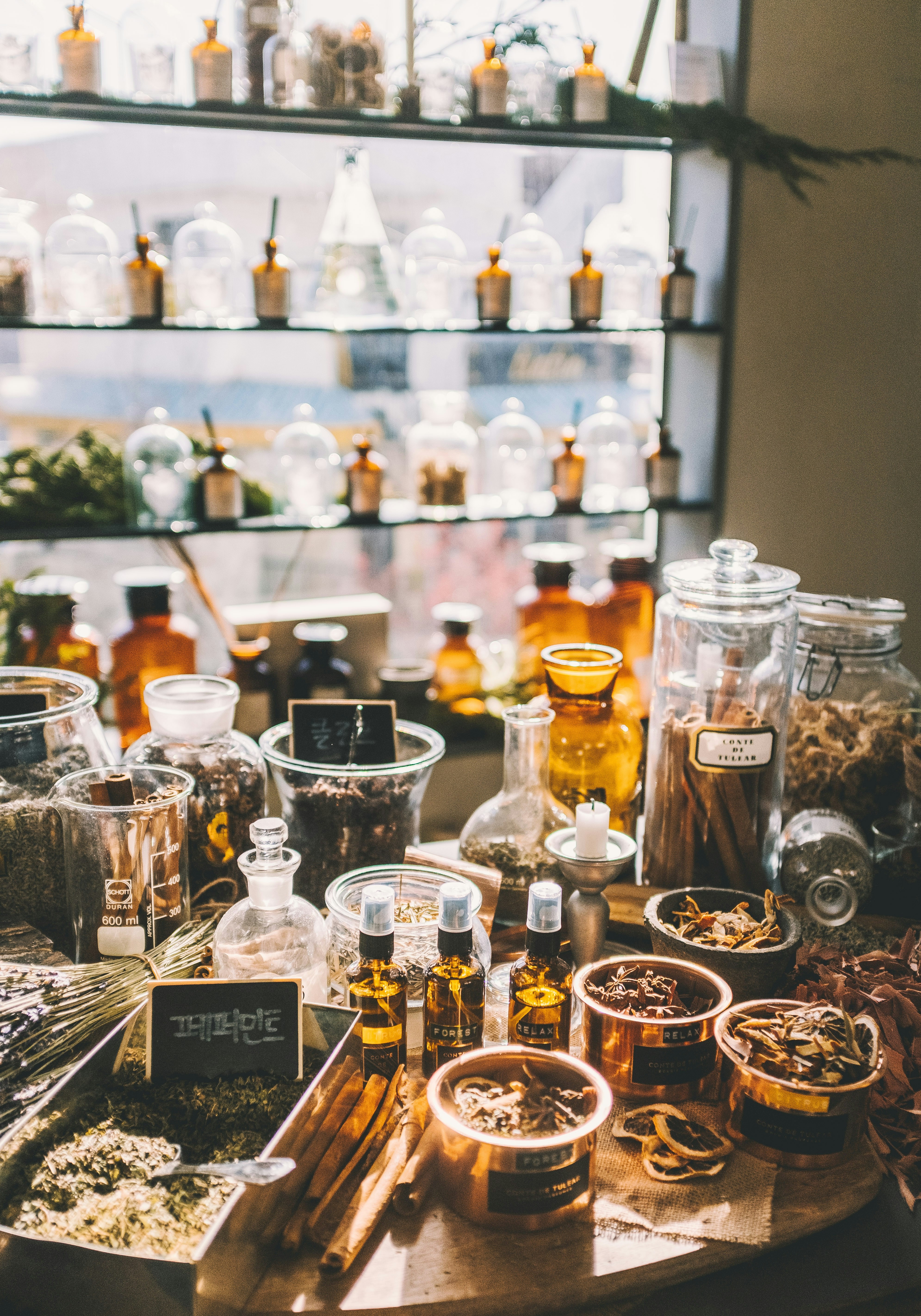 A shelf of cleaning products arranged neatly, a mix of conventional and natural options, natural light