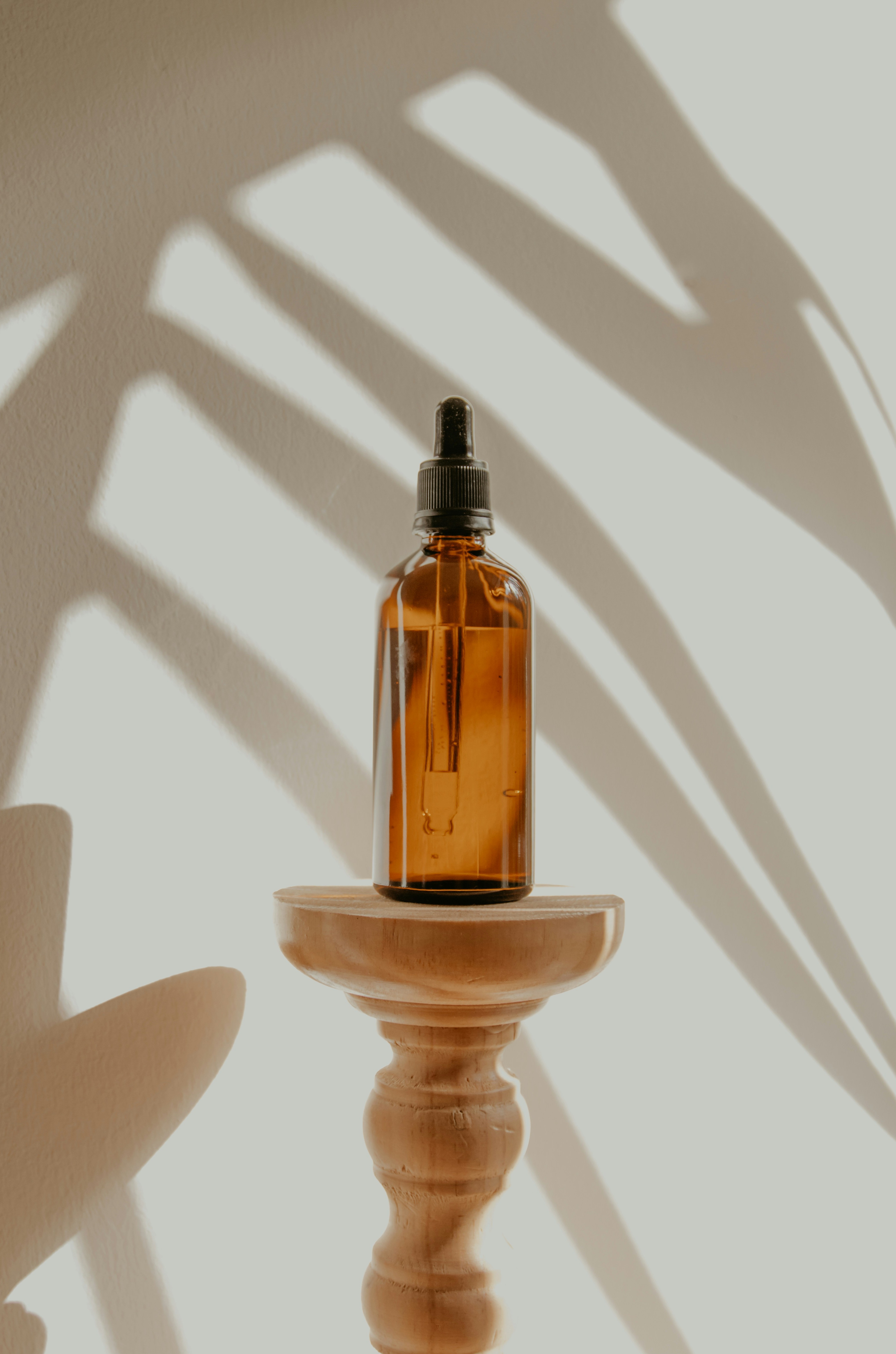 A wooden comb being drawn through healthy hair in natural window light